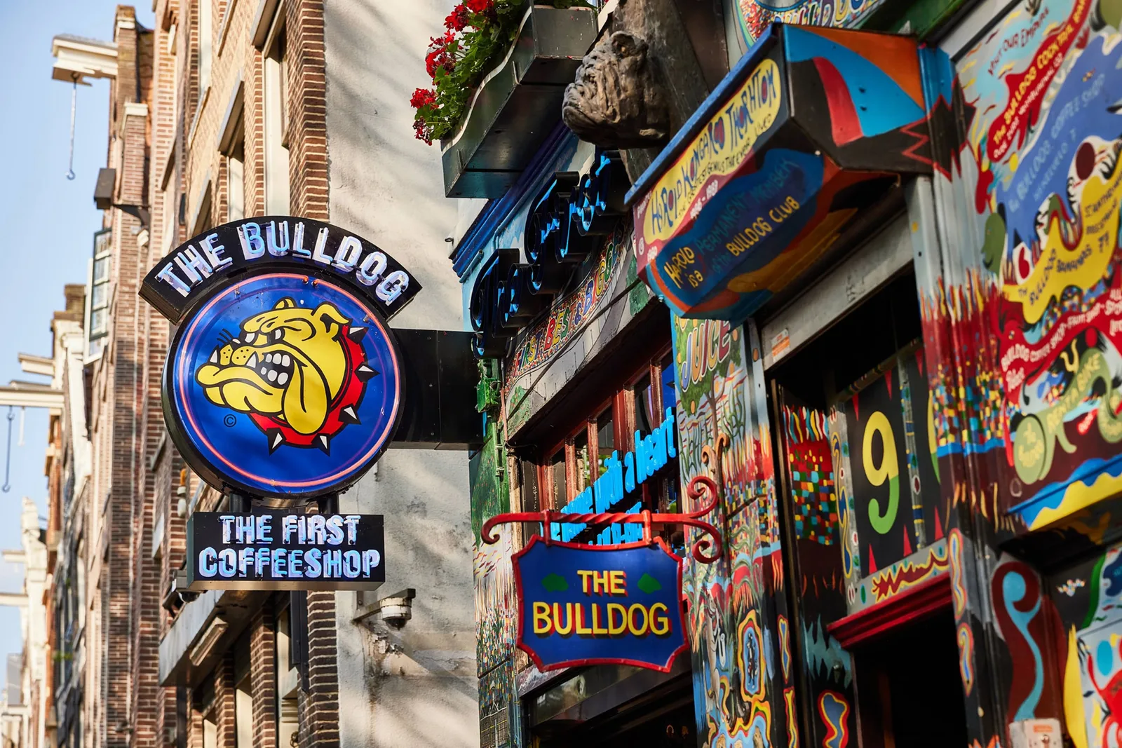 The Bulldog's painted facade on the canal, under its ‘the first coffeeshop’ sign